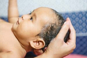 baby getting shampooed to relieve cradle cap 