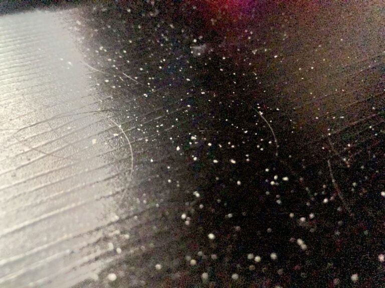 Loose shed dandruff flakes and hairs photographed outside the scalp.