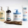 Happy Cappy routine bottles beside raw licorice root sticks, the extract used to soothe redness