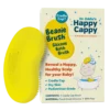 Happy Cappy Beanie Brush, a yellow food-grade silicone cradle cap bath brush, beside its box