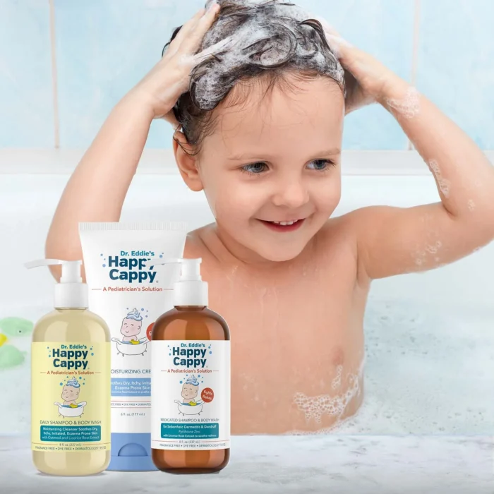 Toddler lathering their hair in the bath with the three Happy Cappy routine products in front