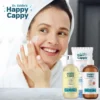 Smiling woman in a towel applying moisturizing cream to her cheek with the routine products in front