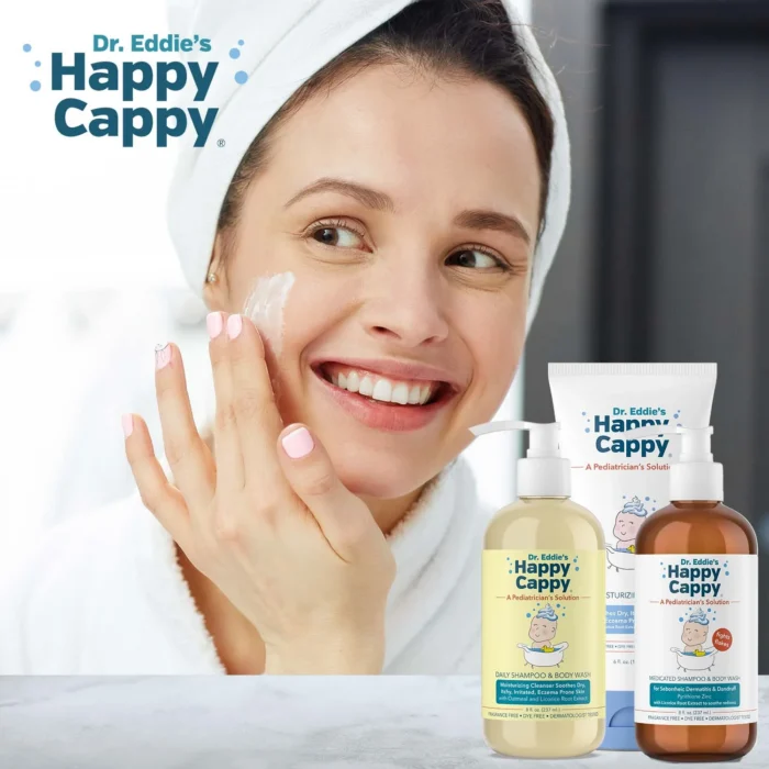 Smiling woman in a towel applying moisturizing cream to her cheek with the routine products in front