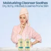 Woman in a robe with two daily wash bottles, a moisturizing cleanser for dry itchy eczema-prone skin