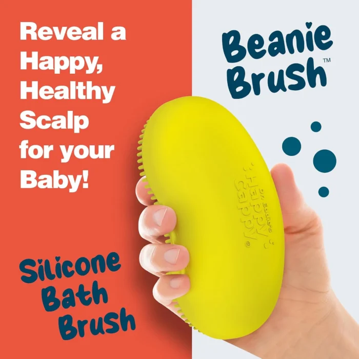 Hand holding the yellow Happy Cappy Beanie Brush, showing its back and curved shape.