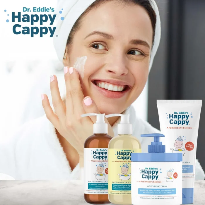 Smiling woman in a towel patting Happy Cappy moisturizing cream onto her cheek, product set in front